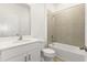 Clean bathroom with a white single sink vanity, a bathtub, and neutral tiling at 797 Lemon Ave, Fruitland Park, FL 34731