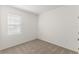Cozy carpeted bedroom with a window and neutral walls, ready for personalization at 797 Lemon Ave, Fruitland Park, FL 34731