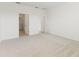 Bright bedroom with neutral carpet, walk-in closet, and en-suite bathroom access at 797 Lemon Ave, Fruitland Park, FL 34731