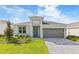 Charming single-story home with a gray garage door and a well-manicured front yard at 797 Lemon Ave, Fruitland Park, FL 34731