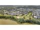 Aerial view showcasing waterfront homes in a community near a body of water, featuring green space and trails at 859 Easley Ave, Winter Garden, FL 34787