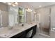 Bathroom featuring double sinks, quartz countertops, dark wood cabinets, and a tiled shower and bathtub at 859 Easley Ave, Winter Garden, FL 34787