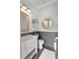Charming half-bathroom with rustic wood accents, a stylish mirror, and modern sink at 859 Easley Ave, Winter Garden, FL 34787