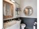 Charming half-bathroom with rustic wood accents, a stylish mirror, and modern sink at 859 Easley Ave, Winter Garden, FL 34787