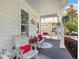 Relaxing front porch seating with hanging plants and 'Welcome to our Porch' sign at 859 Easley Ave, Winter Garden, FL 34787