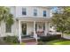 Charming two-story home with a covered front porch, a porch swing, and curb appeal at 859 Easley Ave, Winter Garden, FL 34787