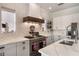 Modern kitchen featuring stainless steel appliances, quartz countertops, and ample storage space at 859 Easley Ave, Winter Garden, FL 34787
