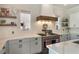 Bright kitchen featuring white brick walls, stainless steel appliances and light gray cabinets at 859 Easley Ave, Winter Garden, FL 34787