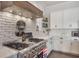 Bright kitchen featuring white brick walls, stainless steel appliances and white cabinets at 859 Easley Ave, Winter Garden, FL 34787