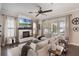 Bright living room with a fireplace, large windows and a comfortable sectional sofa at 859 Easley Ave, Winter Garden, FL 34787