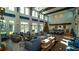 Spacious lounge area with high ceilings, large windows, and elegant furniture and a christmas tree at 859 Easley Ave, Winter Garden, FL 34787