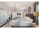 A beautifully designed main bedroom featuring an elegant chandelier and decor for a peaceful atmosphere at 859 Easley Ave, Winter Garden, FL 34787
