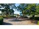Community playground with wooden play structures, benches and surrounding greenery near the lake at 859 Easley Ave, Winter Garden, FL 34787