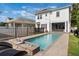 Backyard view of a sparkling pool with an outdoor seating area and fenced in yard at 859 Easley Ave, Winter Garden, FL 34787