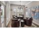 Sitting room with leather chairs, a chandelier, and a view of the pool area at 859 Easley Ave, Winter Garden, FL 34787