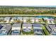 An aerial panorama featuring beautiful homes, sparkling swimming pools, and a scenic lake, all set amidst vibrant green landscapes at 8622 La Isla Dr, Kissimmee, FL 34747