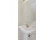 Pedestal sink and oval mirror in a well-lit bathroom at 8622 La Isla Dr, Kissimmee, FL 34747