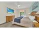 Large bedroom featuring a beach-themed TV and backyard views at 8622 La Isla Dr, Kissimmee, FL 34747