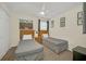 Cozy bedroom with twin beds, ceiling fan, and a closet for storage at 8622 La Isla Dr, Kissimmee, FL 34747