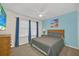 Comfortable bedroom features a ceiling fan, soft carpet, and a mounted TV at 8622 La Isla Dr, Kissimmee, FL 34747