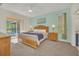 Sunlit main bedroom with backyard access, ceiling fan, and ensuite bathroom at 8622 La Isla Dr, Kissimmee, FL 34747