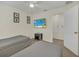 Bright bedroom features matching twin beds, ceiling fan, and TV entertainment at 8622 La Isla Dr, Kissimmee, FL 34747