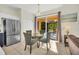 Dining area with backyard access, stainless refrigerator, and tile floors at 8622 La Isla Dr, Kissimmee, FL 34747