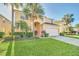 Charming two-story home features a well-manicured lawn and a two-car garage at 8622 La Isla Dr, Kissimmee, FL 34747