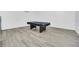 A game room featuring wood-look floors and a contemporary billiards table at 8622 La Isla Dr, Kissimmee, FL 34747