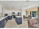 Modern kitchen with an island, stainless steel appliances, and an adjacent dining area at 8622 La Isla Dr, Kissimmee, FL 34747