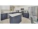 Modern kitchen with an island, white countertops, and stainless steel appliances at 8622 La Isla Dr, Kissimmee, FL 34747