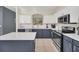This modern kitchen boasts stainless appliances, stone counters, and two-tone cabinets at 8622 La Isla Dr, Kissimmee, FL 34747