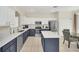 Bright kitchen features an island, white countertops, stainless appliances, and tile flooring at 8622 La Isla Dr, Kissimmee, FL 34747