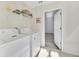 Convenient laundry room with washer, dryer, and storage shelving at 8622 La Isla Dr, Kissimmee, FL 34747