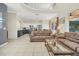 Spacious living room opens to a modern kitchen with stainless steel appliances and dark cabinetry at 8622 La Isla Dr, Kissimmee, FL 34747