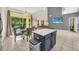 Open concept living room features large sliding glass doors, vaulted ceilings, and access to the kitchen at 8622 La Isla Dr, Kissimmee, FL 34747
