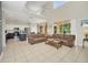 Bright living room showcasing an open floor plan connecting to a kitchen with an island at 8622 La Isla Dr, Kissimmee, FL 34747