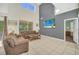 Spacious living room with soaring ceilings, beach art, and comfortable seating at 8622 La Isla Dr, Kissimmee, FL 34747