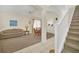 Cozy living room with neutral tones and an open layout, seamlessly connected to dining area at 8622 La Isla Dr, Kissimmee, FL 34747