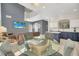 View of open-concept dining, kitchen, and living room areas with large staircase at 8622 La Isla Dr, Kissimmee, FL 34747