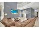 Sun-filled living room with staircase, comfortable seating, and beach-themed decor at 8622 La Isla Dr, Kissimmee, FL 34747