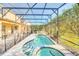 An inviting screened pool and spa with an outdoor patio area provide the perfect space for entertaining and enjoying the outdoors at 8622 La Isla Dr, Kissimmee, FL 34747