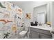 Bright bathroom featuring a vanity with gray cabinetry and a fun dinosaur-themed shower curtain at 9227 Sommerset Hills Dr, Davenport, FL 33896