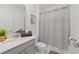 Neutral bathroom with a granite vanity, modern fixtures, and a gray shower curtain at 9227 Sommerset Hills Dr, Davenport, FL 33896