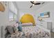 Bright ' bedroom with twin beds, playful wall decals, and a mounted TV at 9227 Sommerset Hills Dr, Davenport, FL 33896