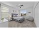 Bright bedroom with a large window, neutral decor, plush bed, and a cozy beanbag chair at 9227 Sommerset Hills Dr, Davenport, FL 33896