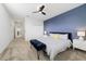 Stylish bedroom featuring a blue accent wall, plush bed, and a modern design, creating a cozy retreat at 9227 Sommerset Hills Dr, Davenport, FL 33896