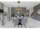 Elegant dining area with modern chandelier, stylish chairs, and decorative wall accents at 9227 Sommerset Hills Dr, Davenport, FL 33896