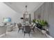Elegant dining area with modern chandelier, stylish chairs, and decorative wall accents at 9227 Sommerset Hills Dr, Davenport, FL 33896