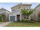 Charming two-story home with a stone accent wall, a green garage door, and a well-manicured lawn at 9227 Sommerset Hills Dr, Davenport, FL 33896